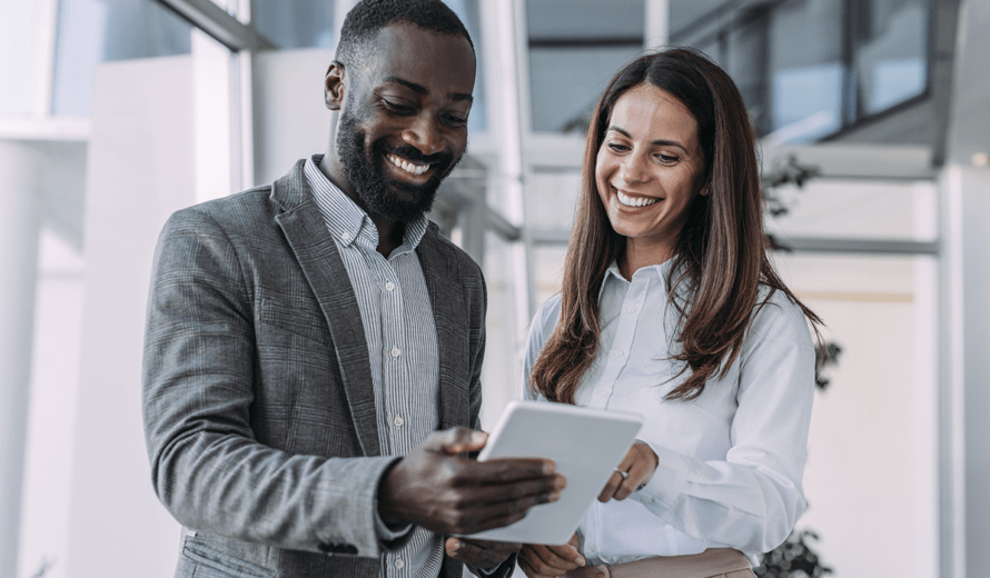 man and woman looking at a tablet